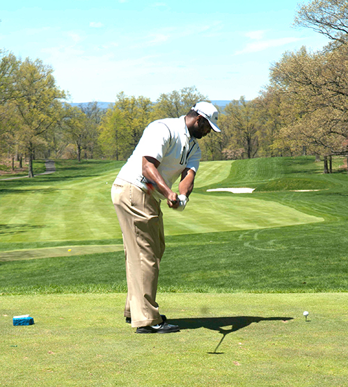 Chris Canty takes a practice swing at the Champions Golf Classic_Heard and Scene_500