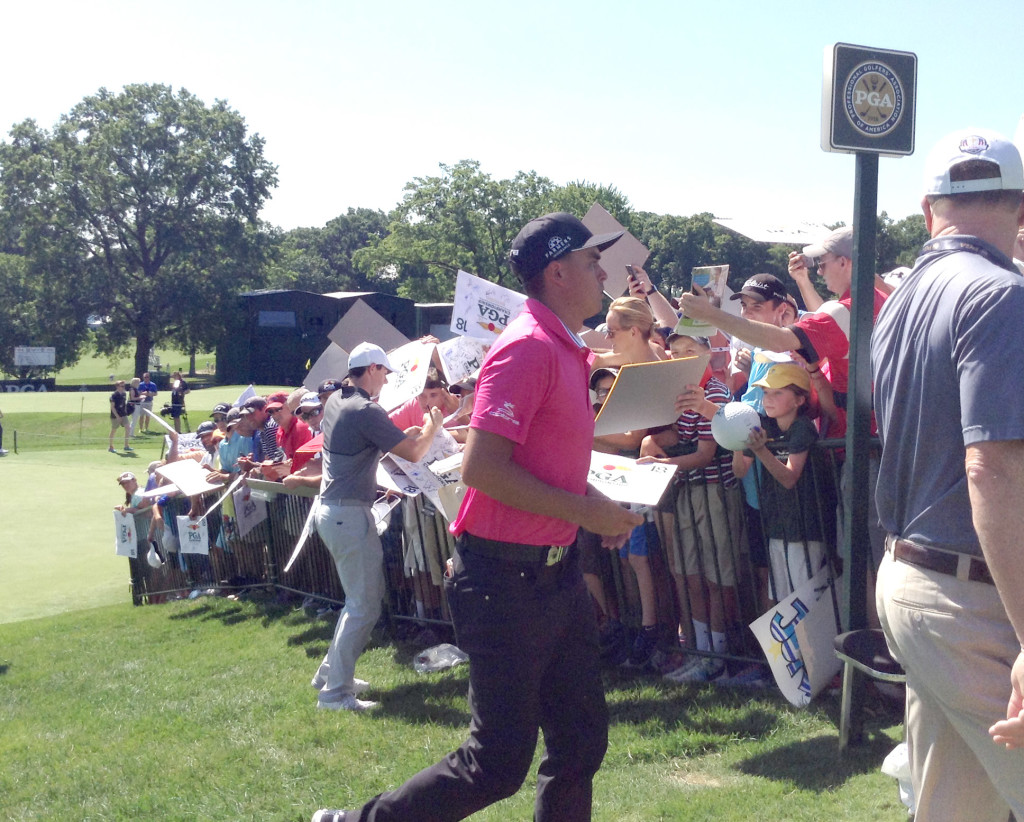 Rory Mcllroy and Rickie Fowler signing autographs during Wednesday's practice round. 