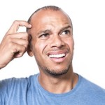 Portrait of a mixed race man scratching his head in confusion